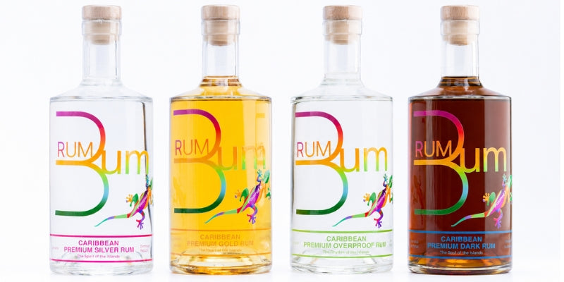 Four Rum Bum bottles with cork stoppers lined next to one another