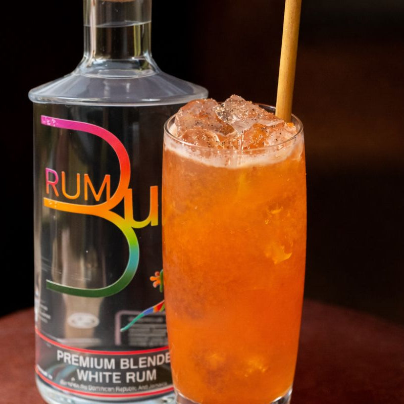 rum bum no.1 award winning white rum next to orange cocktail