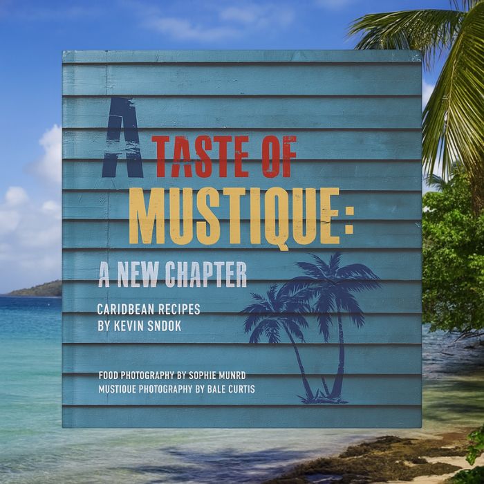 A Taste of Mustique cookbook with Caribbean beach backdrop