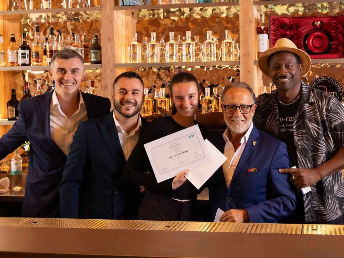 Anya Garrow holds her Daiquiri Master certificate alongside Ian Burrell and Salvatore Calabrese