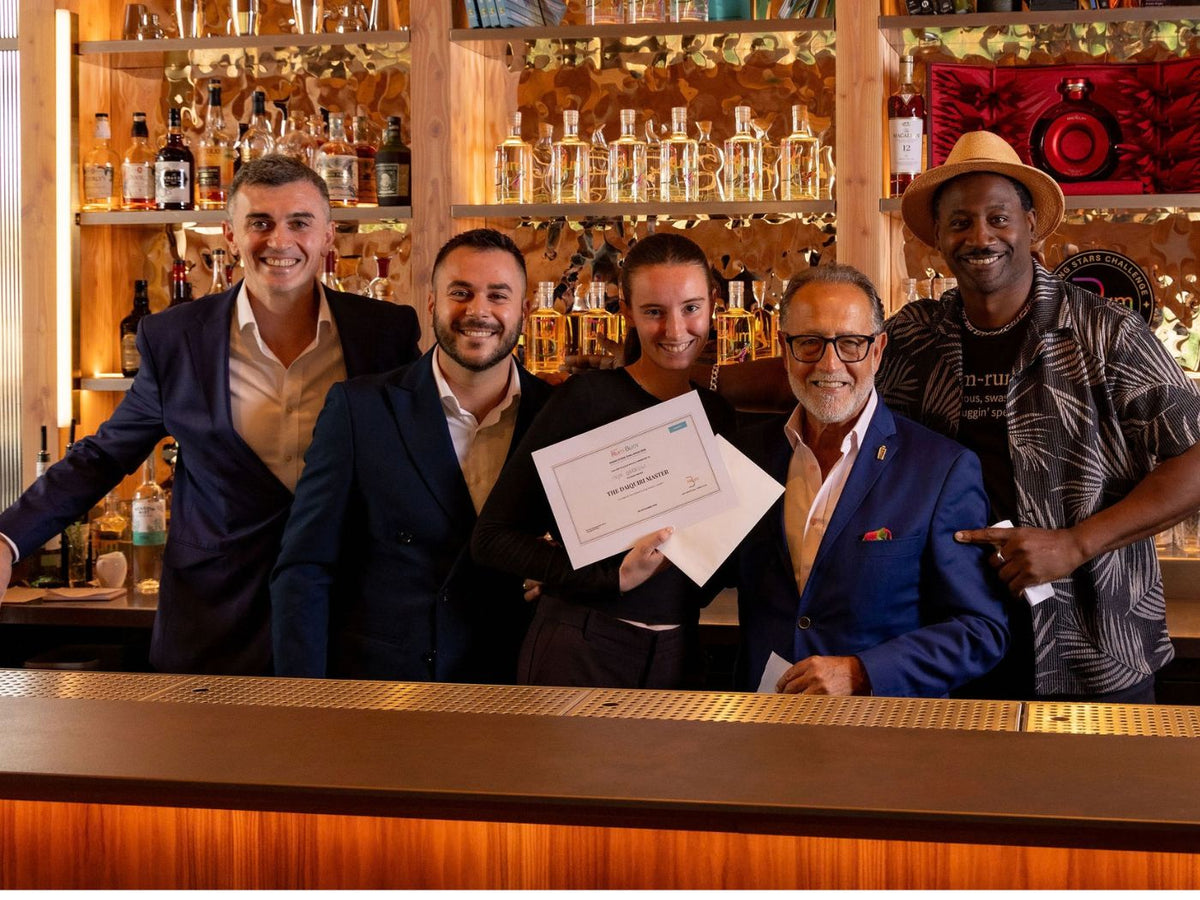 Anya Garrow holds her Daiquiri Master certificate alongside Ian Burrell and Salvatore Calabrese