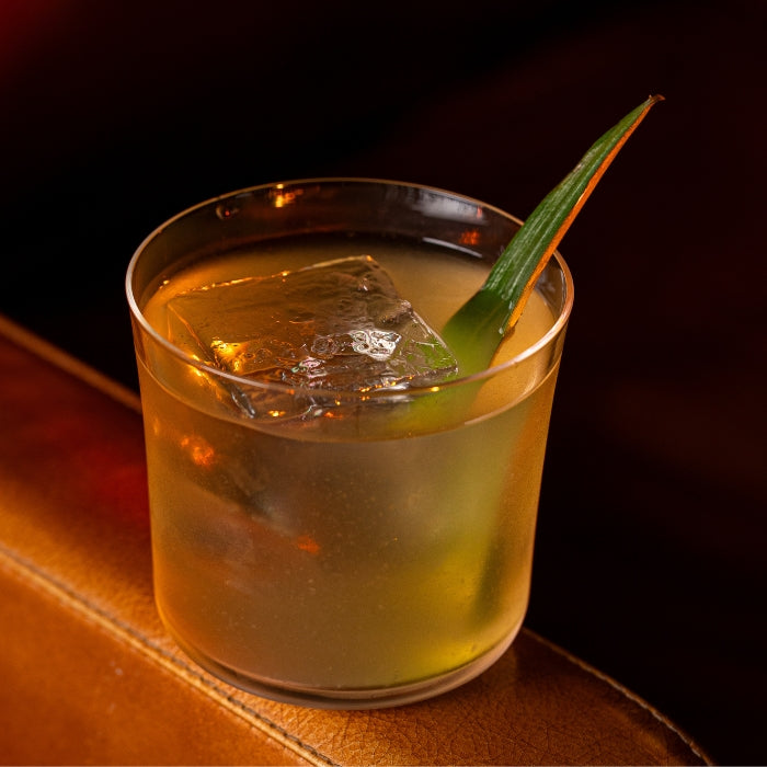 Clarified piña colada with a pineapple leaf garnish