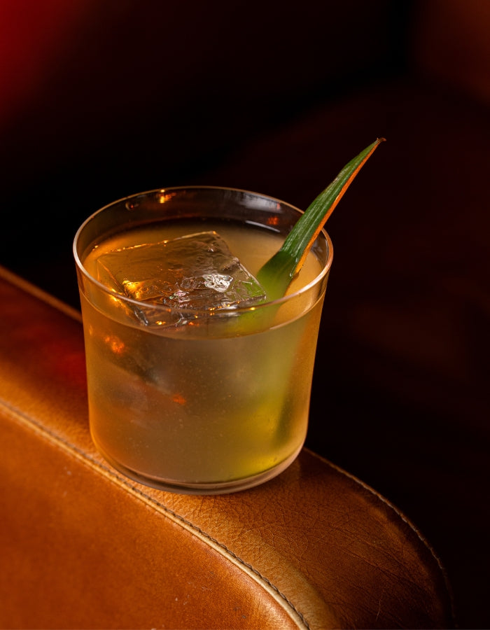 Clarified piña colada with a pineapple leaf garnish