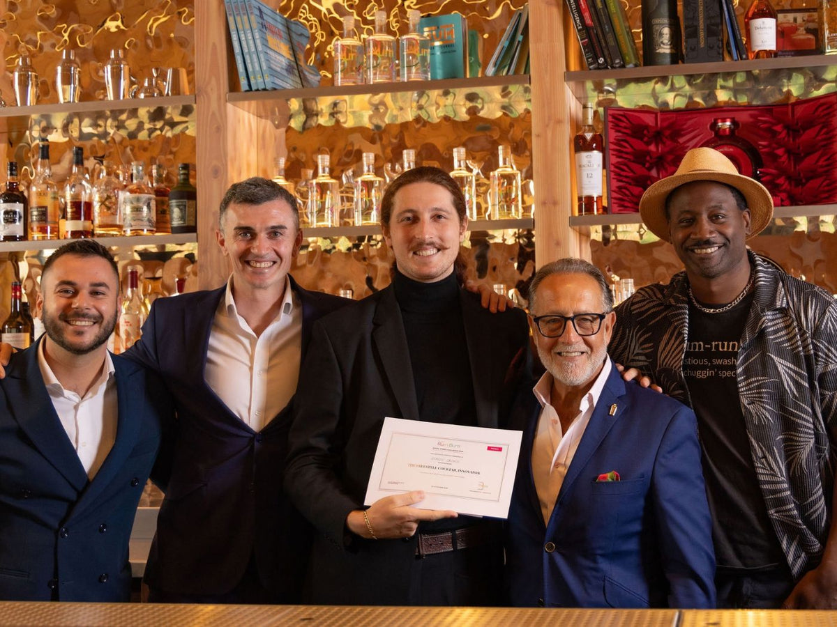 Giorgio Caldesi holds his Freestyle Cocktail Innovator certificate with the judging team