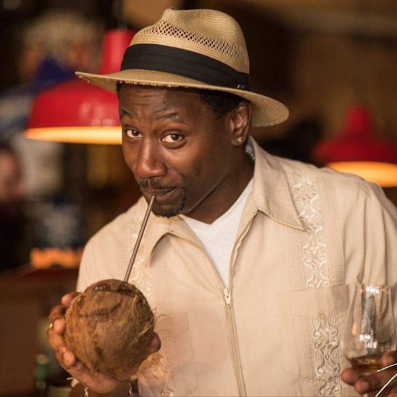 Ian Burrell drinking from a coconut