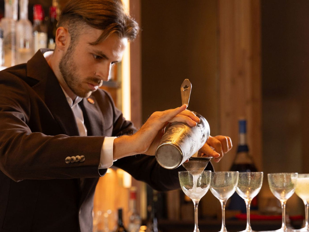 James Lawson strains a cocktail into a coupe glass during the Rising Stars Challenge