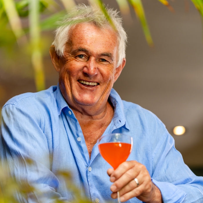 Rum Bum founder Kevin Snook holding a rum cocktail