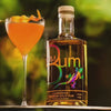 The Original Rum Bum Premium Gold Rum beside an orange cocktail