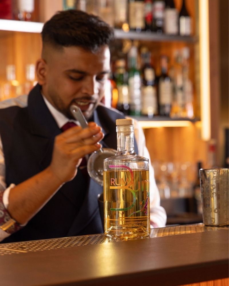 Rising Stars finalist prepares a cocktail beside a bottle of Rum Bum Gold Rum