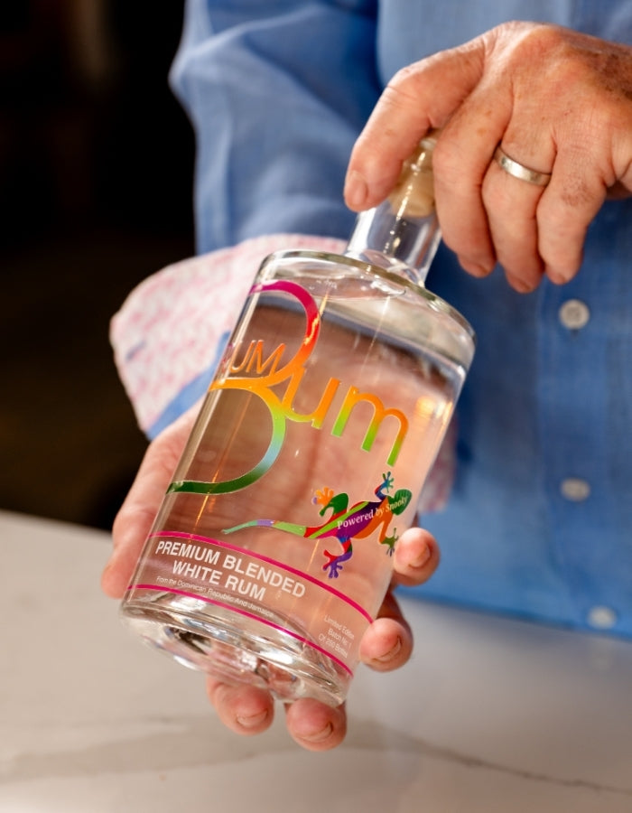 Rum Bum Premium White Rum bottle held in two hands