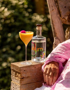 Rum Bum Signature Rum beside a tropical cocktail