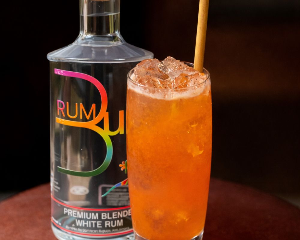 rum bum no.1 award winning white rum next to orange cocktail