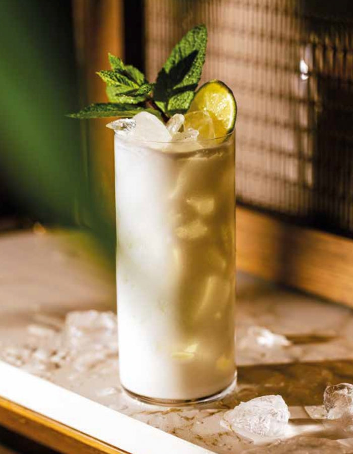 White rum cocktail garnished with mint and lime